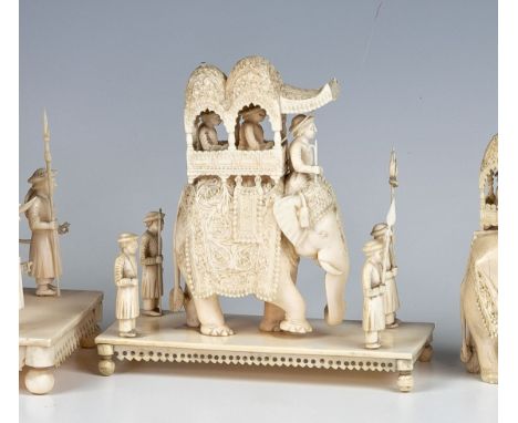 An Indian carved ivory figure of an elephant howdah party, late 19th century, the caparisoned elephant with two nobles, rider