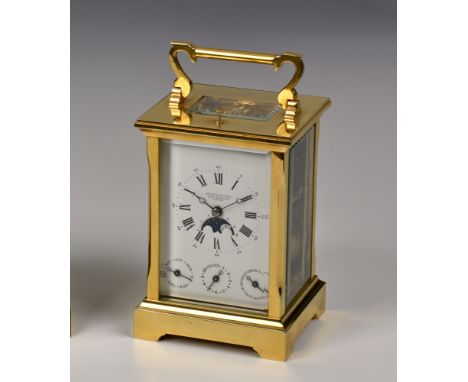 A brass repeating carriage clock by Searle & Co. Ltd., Royal Exchange, London with complications, in Anglaise case, the signe