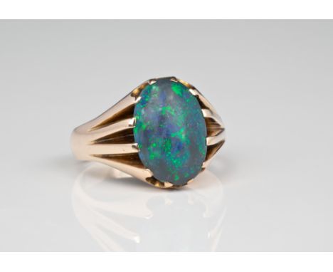 A yellow gold and black opal signet ring, the cabochon opal over split shoulders, ring size Q½.