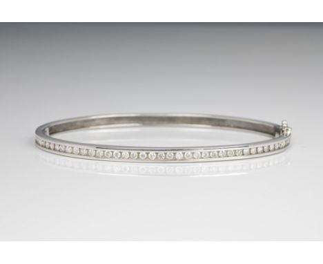 A 9ct white gold and diamond bangle, channel set with brilliant cut diamonds, approx. total weight 0.65cts.