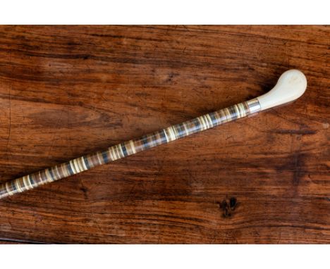 A 19th century ivory and horn walking cane, the shaped ivory handle on a tapered, sectional horn stick with unmarked silver m