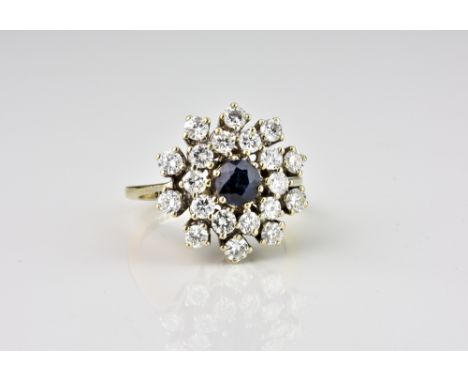 A 14ct white gold, sapphire and diamond floral cluster ring, the central round cut sapphire within a flower shaped, two tier 