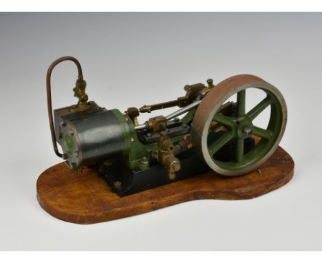 A well engineered stationary horizontal single cylinder live steam engine, single spoked flywheel to side, painted khaki gree