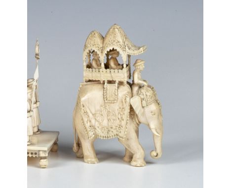 An Indian carved ivory figure of an elephant howdah, late 19th century, the caparisoned elephant with two nobles and rider, f