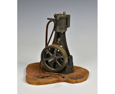 A well engineered stationary vertical single cylinder live steam engine, single spoked flywheel to side, painted grey, standi