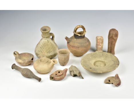 A collection of ancient Grecian or Hellenistic pottery, including a spindle form perfume flask, 6½in. (16.5cm.) long; a buff 