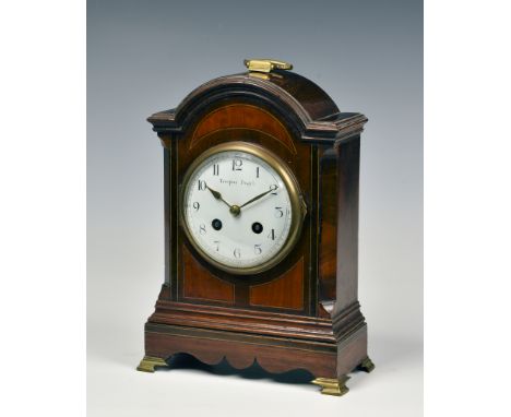 A late 19th century mahogany arched mantel clock, with French twin train movement with platform escapement, striking the hour