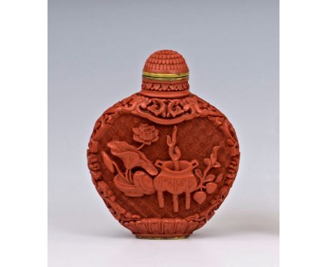 A finely carved Chinese cinnabar lacquer snuff bottle, Qianlong mark and probably period (1736-95), the flattened ovoid body 