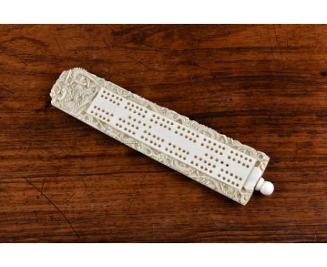A Chinese Canton ivory cribbage board, 19th century, carved with dragons, the spherical finial unscrewing to reveal six pegs,