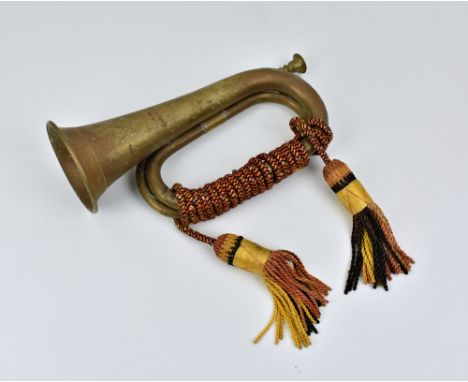 A German WWII brass bugle, unmarked, cones with red, gold and black portepee.