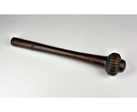 A Fijian Ula throwing club, 20th century, with lobe carved head and tooth and feather carved handle, 20in. (50.75cm.) long.* 