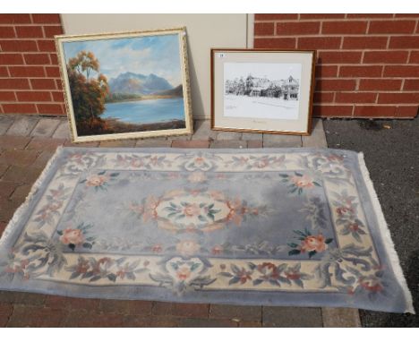 Light blue living room rug and two framed prints of landscape scenes (3)