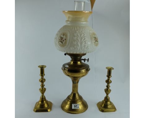 Brass rise and fall candlesticks together with similar oil lamp (3)