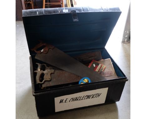 Large tin travel trunk with a collection of hand tools held within to include saws, planes, clamps, etc