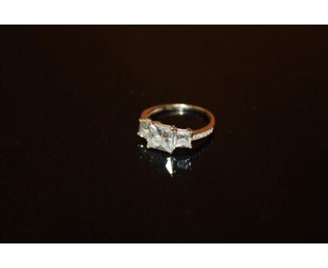 A LADIES 9 CARAT WHITE GOLD THREE STONE DRESS RING - SIZE K 1/2 - WEIGHT 2.1 GRAMS APPROX