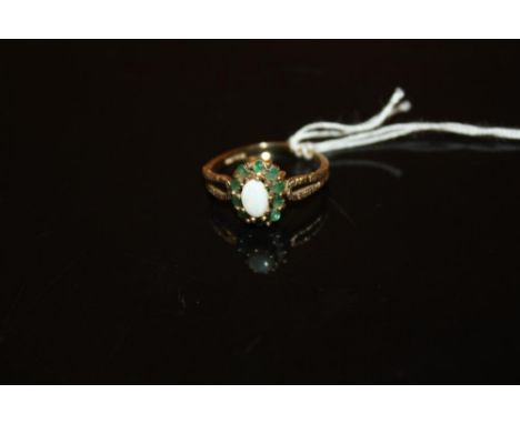 A 9 CARAT GOLD OPAL AND GREEN STONE DRESS RING - SIZE M - WEIGHT 1.9 GRAMS APPROX