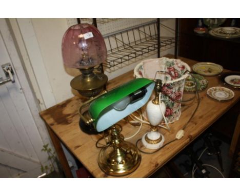 A CONVERTED OIL LAMP WITH PINK GLASS SHADE A/F TOGETHER WITH A MODERN BANKERS LAMP PLUS ANOTHER (3)