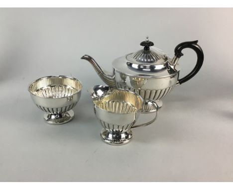 GROUP OF SILVER PLATE, including a photograph frame on swing stand, 27.5cm high, a table lamp and a three piece tea service