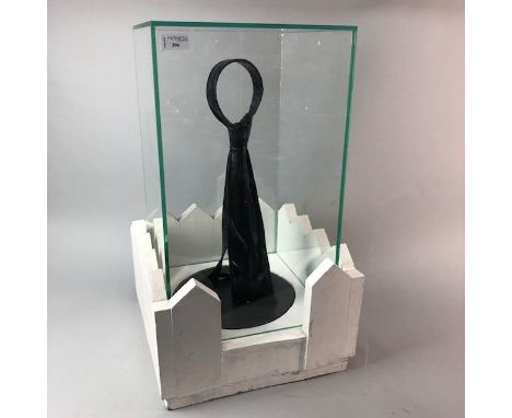 V PREIK, THE TIE, resin sculpture, enclosed in a glass case, approximately 62cm high overall