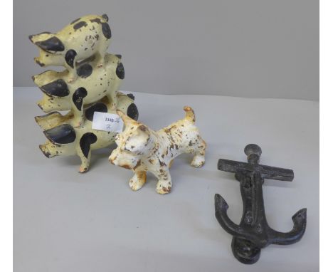 A cast iron pig doorstop, a cast iron model of a terrier and a door knocker 