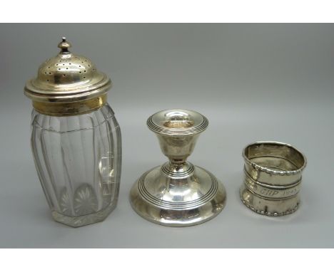 A silver candlestick, a silver napkin ring, a/f, and a 19th Century silver topped glass shaker 