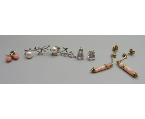 A pair of silver and cultured pearl earrings, two pairs of coral earrings and a pair of studs 