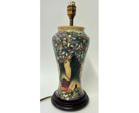 A Moorcroft lamp decorated with trees and mountains, height 38cm including stand.
