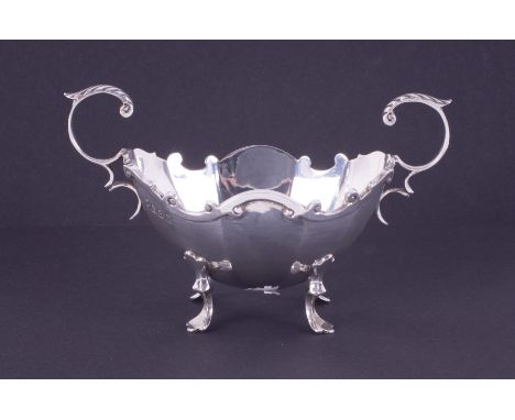 An Edw VII silver scroll handled small sugar bowl on pad feet, Glasgow hallmark, circa 1907-08, makers mark R &amp; WS, appro