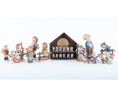 A collection of nine Hummel figures including 'Just Resting' together with twelve Authentic Hummel thimble collection with st