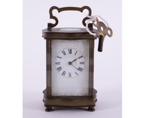 A small carriage clock with key, height including handle 15cm.