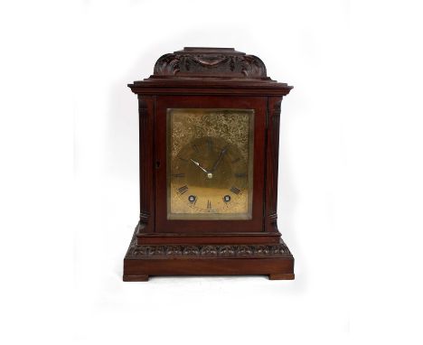 A late 19th early 20th century mahogany mantle clock, 8 day movement with chased gilt metal face. 