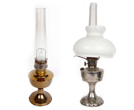 Two brass oil lamps, one with ceramic lamp shade, together with a box of replacement mantles.