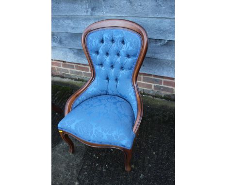 A Victorian nursing chair, button upholstered in a pink velvet, and a spoon back nursing chair, button upholstered in blue fa