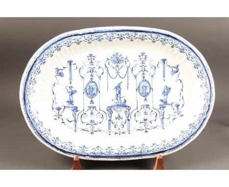 An 18th century Moustiers faience oval charger/serving dish with Berain style Rococo scrollwork with Hercules, Flora and Hera
