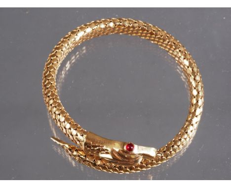 An Italian 18ct gold serpent bracelet with ruby eyes, 43.2gInterior diameter: 57.40mm