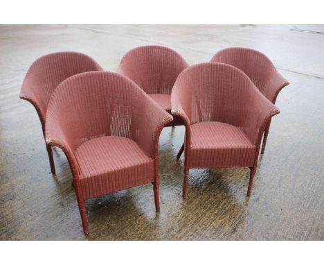 Five 1940s Lloyd Loom armchairs with original "coral" paint finishCondition & Info:27"w x 31"h for all chairs.Some small loss
