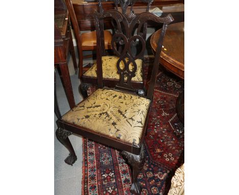 A pair of 18th century carved mahogany pierced splat back dining chairs of Chippendale design with drop-in seats, on cabriole