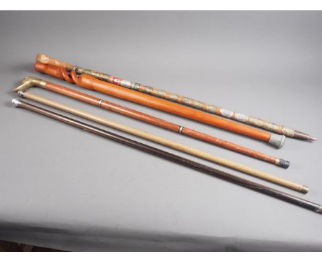 A silver topped coromandel evening cane, another evening cane, a walker's souvenir stick, two other sticks and a leather slip
