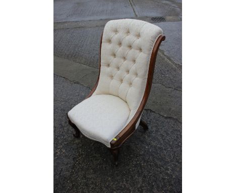 A mid 19th century rosewood showframe low seat nursing chair, button upholstered in a figured brocade