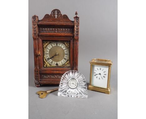 A brass cased carriage clock, 4 1/2" high, a Waterford Crystal clock and an oak cased mantel clock with gilt and silver dial 