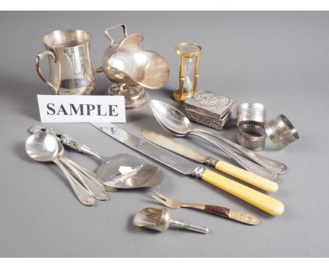 A quantity of silver plated cutlery, napkin rings, an hourglass timer and other items
