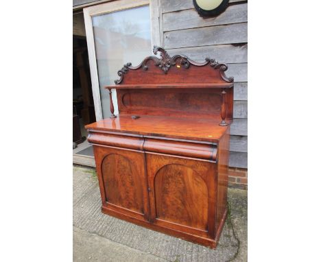 A Victorian mahogany chiffonier with carved ledge back over two drawers and cupboards, on block base, 45" wide, an Edwardian 