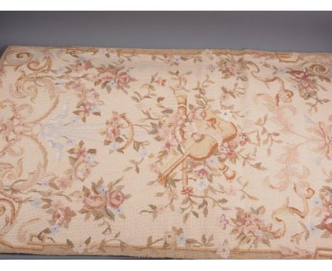 A tapestry panel of 18th century French design with musical instruments and floral scrolls, 47" x 29"