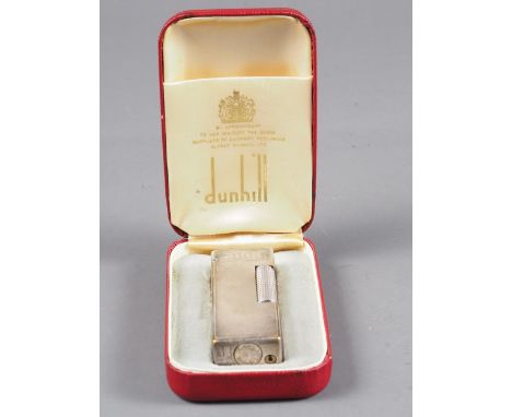 A Dunhill silver plated lighter with engine turned decoration, 2 1/2" high, in original box