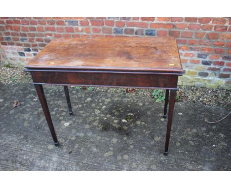 A 19th century mahogany fold over top card table, on square taper supports, 36" wide x 18" deep x 29" high