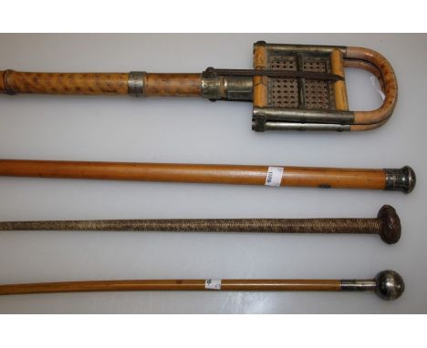 An Edwardian bamboo and cane shooting stick, named Elaine Harrison, a white metal mounted Royal Mahrattas drill stick, a mala