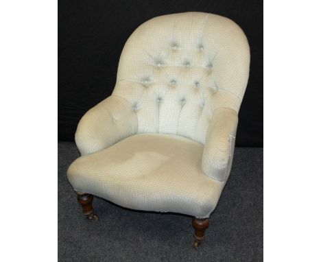 A Victorian button upholstered salon nursing armchair, with serpentine overstuffed seat, on turned forelegs and castors