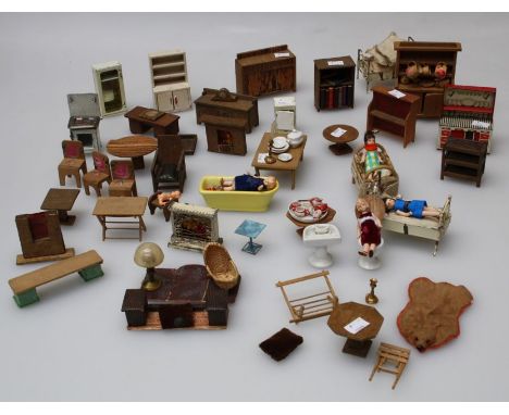 A collection of early to mid 20th century dolls house furniture and effects to include tin plate stove, fridge, dresser, lard