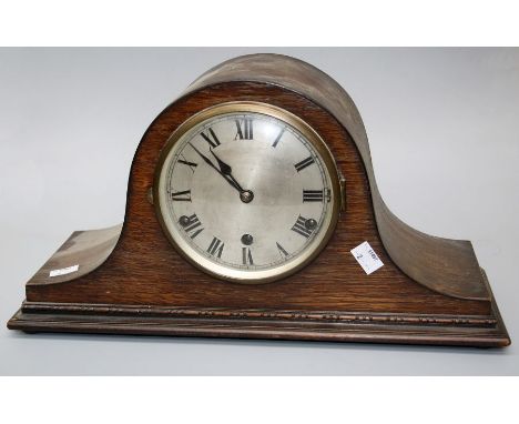 A late 1920's oak Napoleon Hat mantle clock, the eight day Westminster chiming movement striking on gongs, faced by silvered 