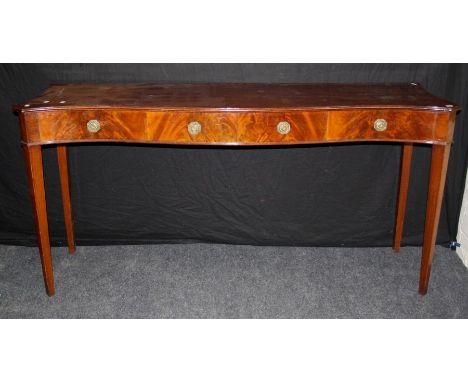 A 19th century George III style mahogany silver table, the serpentine top with moulded edge over four false drawers with laur